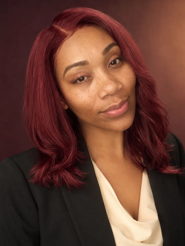 Elise wearing a burgundy shoulder-length cut
