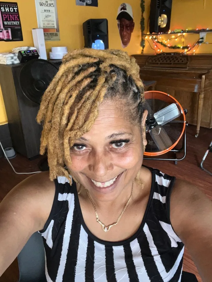 Client with golden locs styled at Magic Hair Boutique